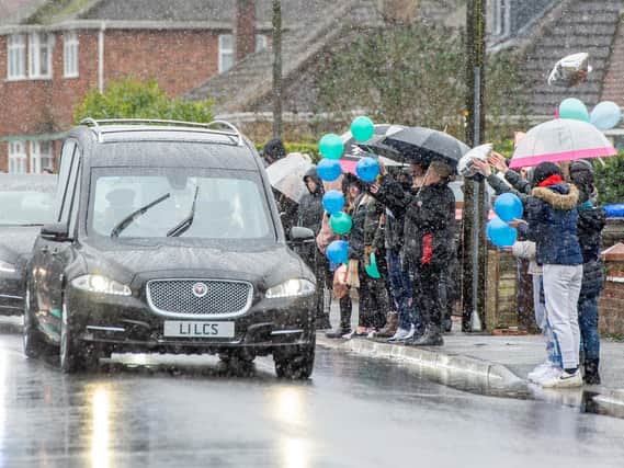 People gathered in the sleet to pay their respects