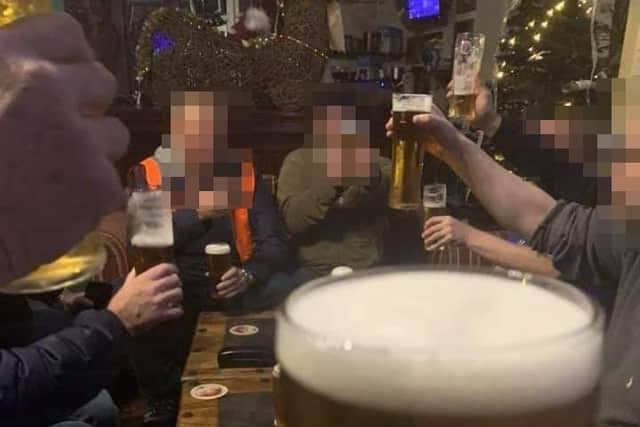 Facebook image showing customers drinking at bar.