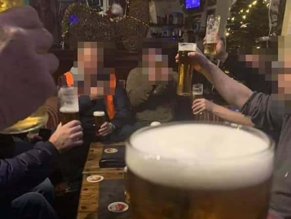 Facebook image showing customers drinking at bar.