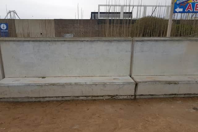 Graffiti removed behind Bottons amusement park at benches on promenade in Skegness.