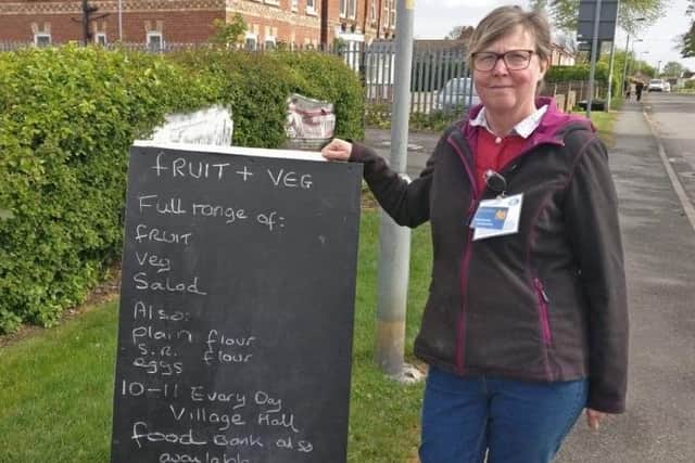 The sign advertising the fruit and veg store outside the village hall.