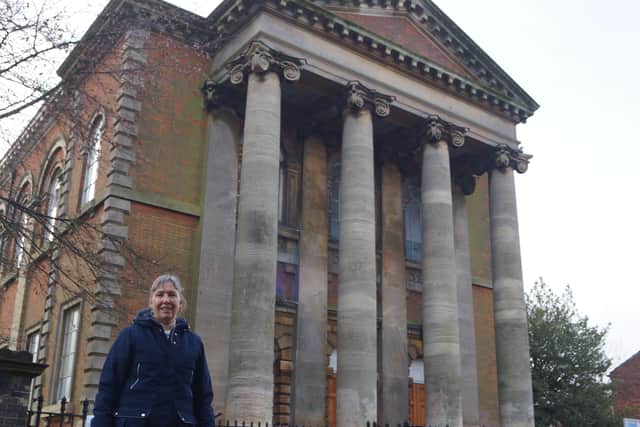 The Rev Heather Wilson outside the imposing church building EMN-210127-153246001