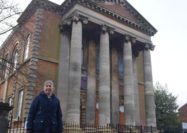 The Rev Heather Wilson outside the imposing church building EMN-210127-153246001