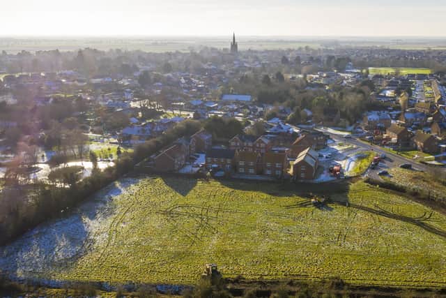 An overhead view of the development site off Kyme Road, with the existing homes in Welchman Way and the rest of Heckington stretching out. Photo: Lindum Homes EMN-210127-121140001