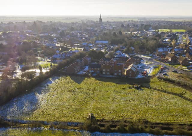 An overhead view of the development site off Kyme Road, with the existing homes in Welchman Way and the rest of Heckington stretching out. Photo: Lindum Homes EMN-210127-121140001