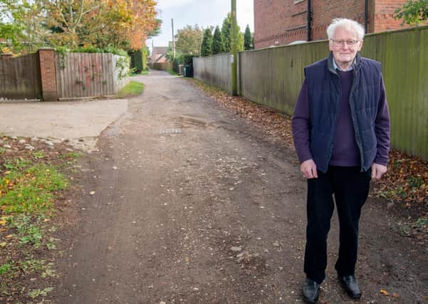 County Councillor Bill Aron at the  section of Holt Lane  which is at the centre of calls for an upgrade