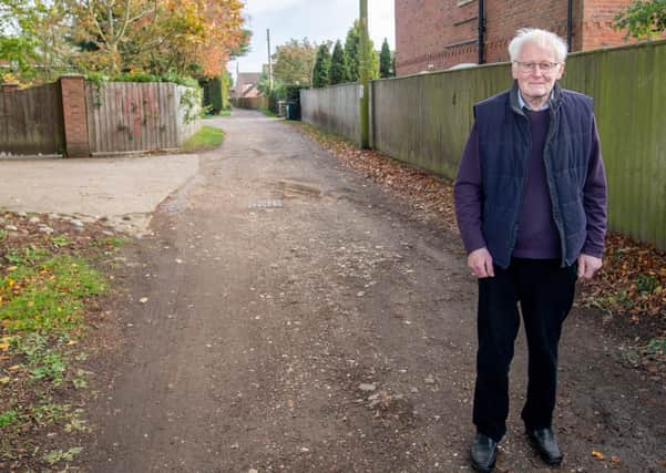 County Councillor Bill Aron at the section of Holt Lane which is at the centre of calls for an upgrade