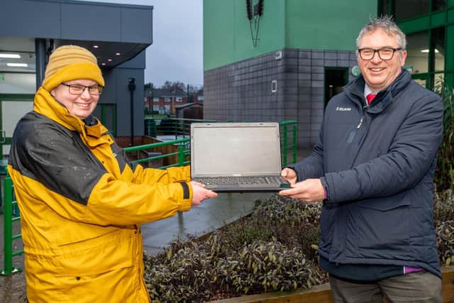 All smiles: Banovallum headteacher Grant Edgar receives the  100th computer from Kelly Teasdale of Sivill Service.