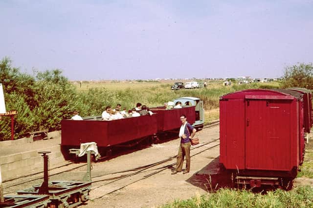 It’s a sunny June day in 1961 and the LCLR has been open for less than a
year but is developing rapidly. A train of two open carriages converted from First World War Class D bogie wagons is ready to depart for the Beach, behind the line’s first loco, Motor Rail ‘Simplex’ “Paul” (builder’s number 3995 of 1926). On the right are former WW1 ambulance vans which once carried potatoes on the Nocton Estates Railway. © Gordon Green