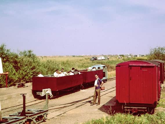 It’s a sunny June day in 1961 and the LCLR has been open for less than a
year but is developing rapidly. A train of two open carriages converted from First World War Class D bogie wagons is ready to depart for the Beach, behind the line’s first loco, Motor Rail ‘Simplex’ “Paul” (builder’s number 3995 of 1926). On the right are former WW1 ambulance vans which once carried potatoes on the Nocton Estates Railway. © Gordon Green