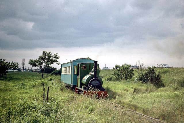 Under lowering skies which are a reminder of why so many holidaymakers deserted British resorts for Spanish sunshine: “Jurassic” and train on their way to Beach and the Fitties camp in 1970.© Trevor Dodgson