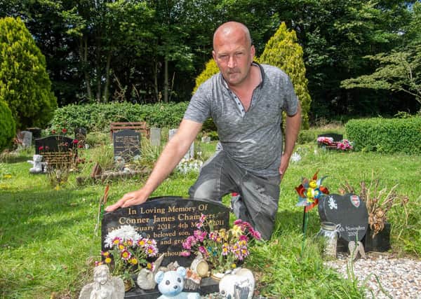 Heartbroken Darren Chambers at the grave of his son Conner, pictured last summer after the first incident.
