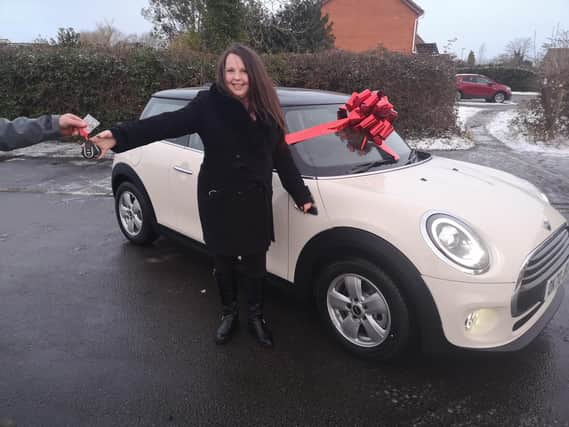 Joanne Roper with  her Mini new One 1.5 Classic worth £19k which she won  in a competition run for .Huawei AppGallery users.