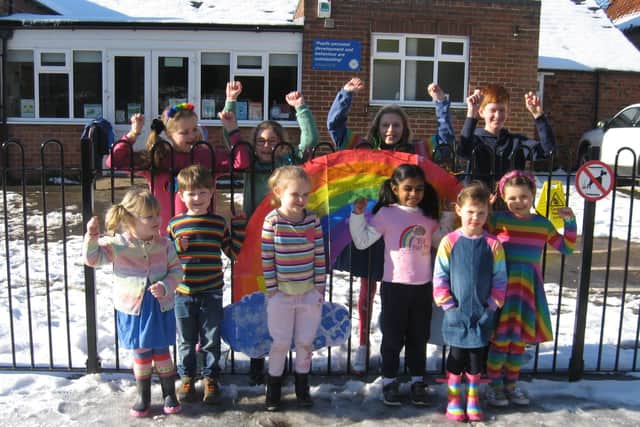 Pupils at Bicker Prep School in colouful outfits with their banner for Rainbow Day. EMN-211102-150204001