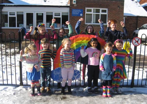Pupils at Bicker Prep School in colouful outfits with their banner for Rainbow Day. EMN-211102-150204001