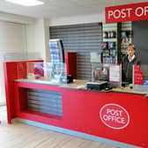 Postmaster Lee Taylor behind the counter of his new post office premises in Sleaford's Southgate Precinct. EMN-211202-170610001