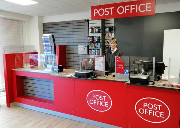 Postmaster Lee Taylor behind the counter of his new post office premises in Sleaford's Southgate Precinct. EMN-211202-170610001