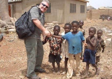 Phil and local children while building a new school in Kenya. EMN-210214-175712001