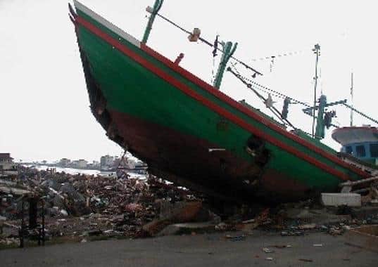 Phil found a boat flung onto the land by the Asian tsunami at Banda Aceh, Indonesia. EMN-210214-175641001