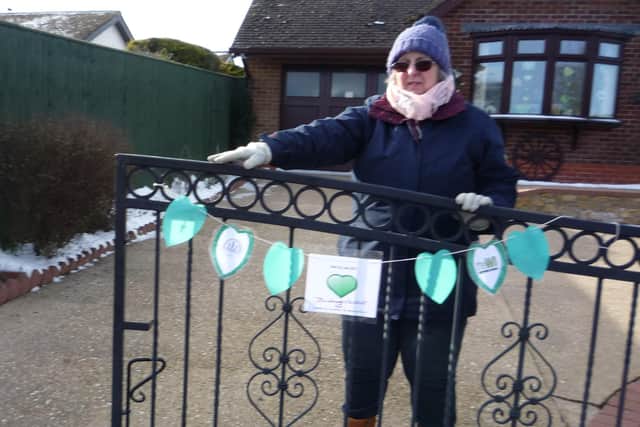 WI president Hilary Harris putting out some green heart bunting