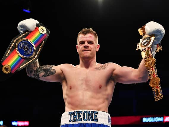 Callum Johnson with his Commonwealth and British belts. Photo: Getty Images