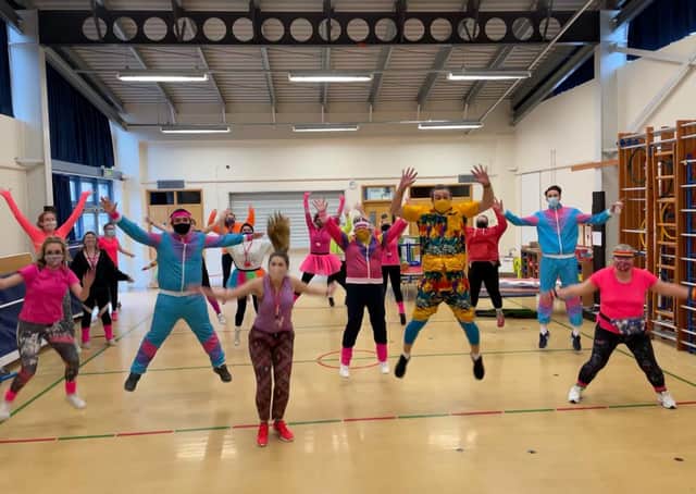 Brightly coloured Church lane School staff join in the Mr Motivator session. EMN-210103-104126001