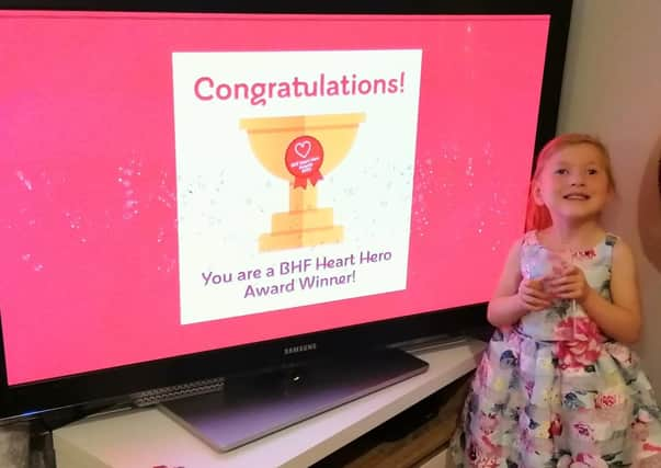 Heart Hero 2020 award winner Sophia Marshall celebrates with her Young Heart Hero Award