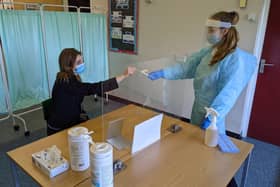 Frances Green, Somercotes Academy Principal, and Testing Assistant Hannah Teagle at one of the Covid-19 testing stations in the county. EMN-210103-134606001