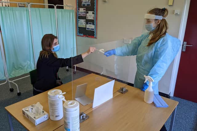 Frances Green, Somercotes Academy Principal, and Testing Assistant Hannah Teagle at one of the Covid-19 testing stations in the county. EMN-210103-134606001