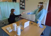 Frances Green, Somercotes Academy Principal, and Testing Assistant Hannah Teagle at one of the Covid-19 testing stations in the county. EMN-210103-134606001