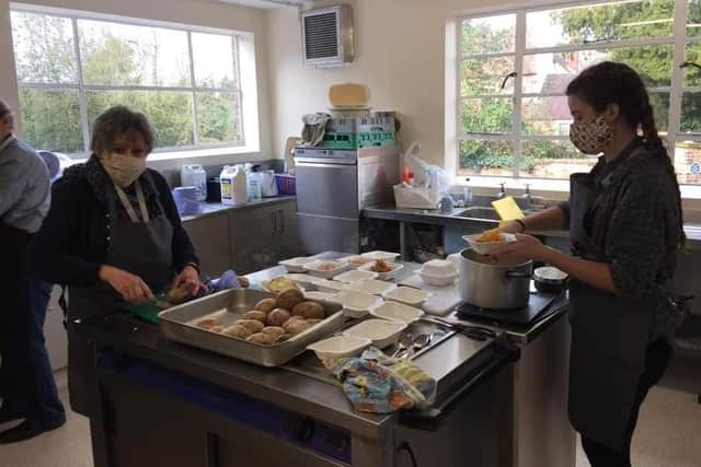 Volunteers at work preparing the free packed lunches
