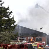 Jets of water are sprayed down onto the roof of tThe Roasting Company. EMN-210403-170056001