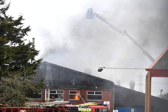 Jets of water are sprayed down onto the roof of tThe Roasting Company. EMN-210403-170056001