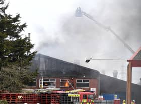 Jets of water are sprayed down onto the roof of tThe Roasting Company. EMN-210403-170056001