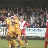 Stuart Douglas is mobbed after opening the scoring.