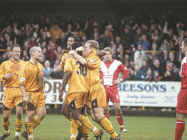 Stuart Douglas is mobbed after opening the scoring.