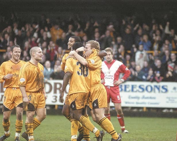 Stuart Douglas is mobbed after opening the scoring.