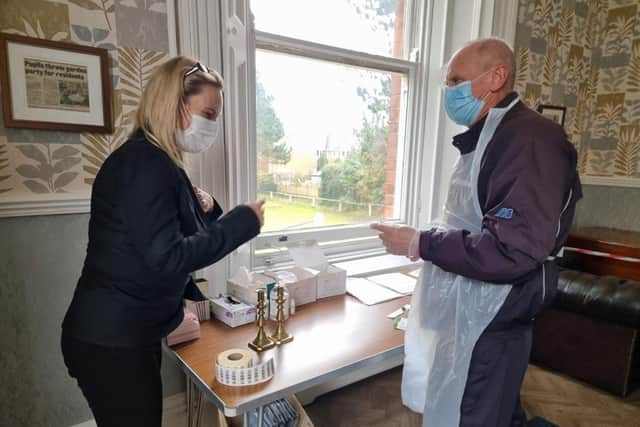 Care home manager Hayley Peace helping visitor John Epton with his lateral flow test.