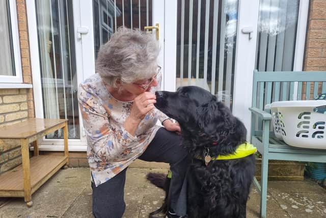 Val Liffen with her black retriever Guide Dog Usher.