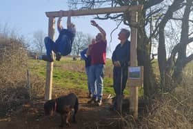 All together now: Rob Short joins volunteers as they get into the swing of things to fit the entrance arch.  All photos supplied by Jill Newby