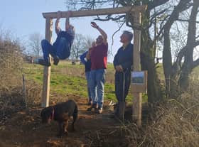 All together now: Rob Short joins volunteers as they get into the swing of things to fit the entrance arch.  All photos supplied by Jill Newby
