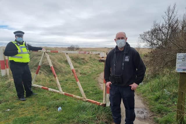 PC Ben Morris and Gibraltar Point Nature Reserve Warden Kevin Wilson at the entrance to the Site of Special Scientific Interest along the coast at Skegness.