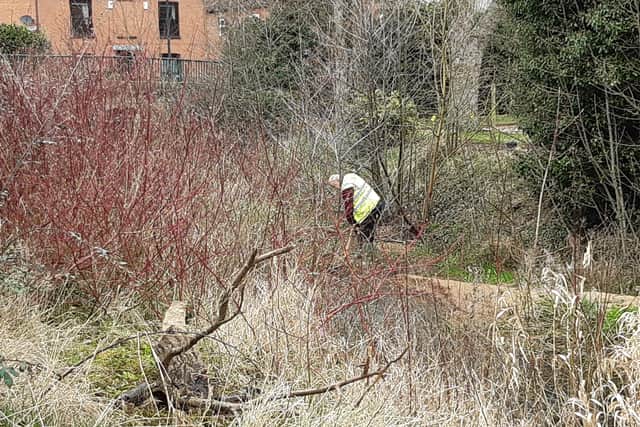 Coun Neil Taylor digs in at the river site EMN-210321-162731001
