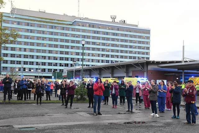 Pilgrim Hospital staff paying tribute to a staff nurse who died of Covid-19, as a parade of emergency vehicles drive past the hospital. EMN-210322-112859005