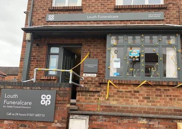 The daffodils on the front window of the funeral home in Louth.