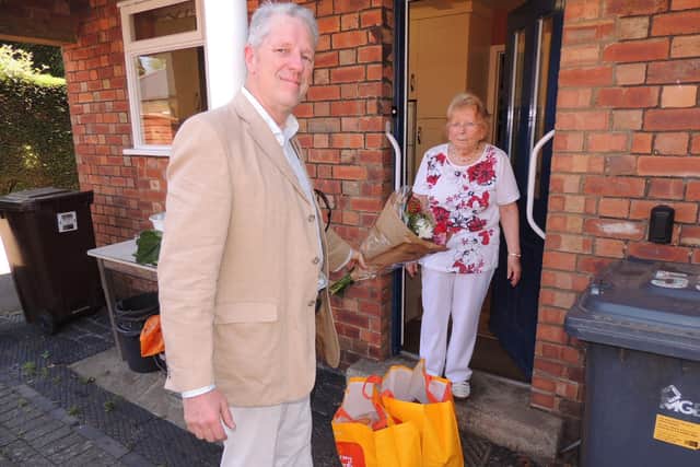 Robert Oates of Holdingham Helpers visits a resident with a delivery. EMN-210323-180716001
