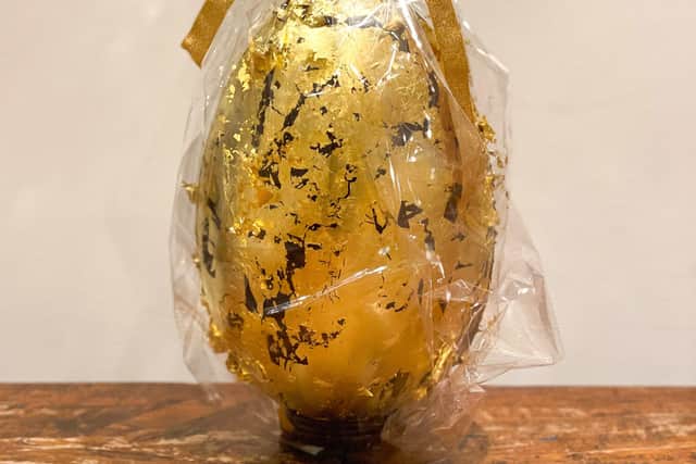 The outer egg is produced using 85% dark chocolate with pistachio and gianduja cream layers and is finally wrapped in 24k edible gold. EMN-210329-123905001