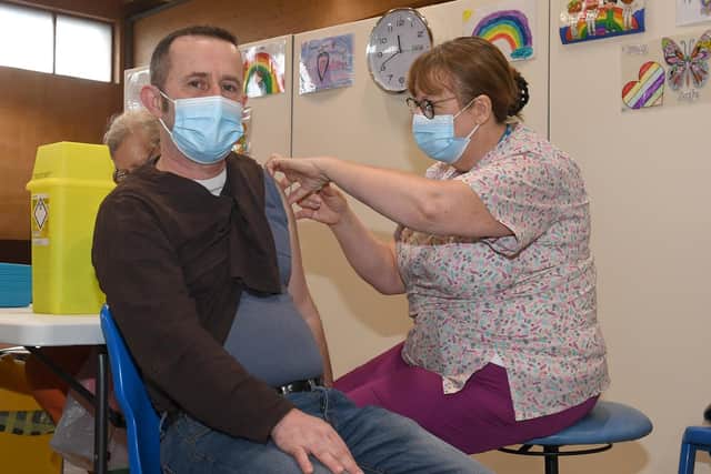 Jackie Burrows administering the vaccine to Carlos De Abreu of Holbeach.