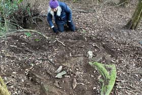 Uncovering the old church window in the grounds of Leadenham House. EMN-211204-200756001