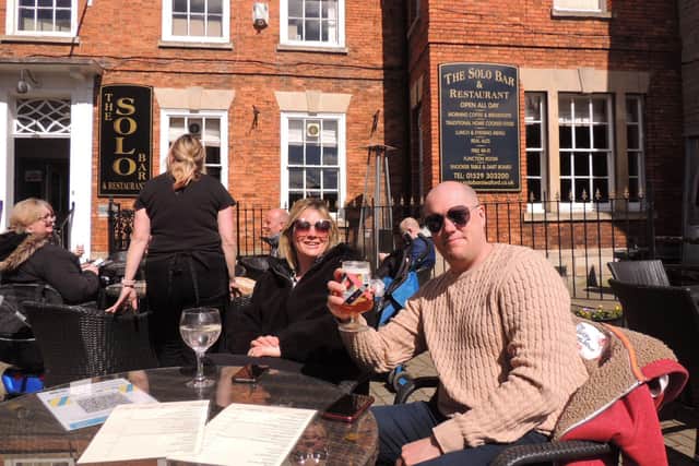 Kyla and Mark Roberts raise a glass at the Solo Bar and Restaurant in Sleaford Market Place. EMN-211204-163439001